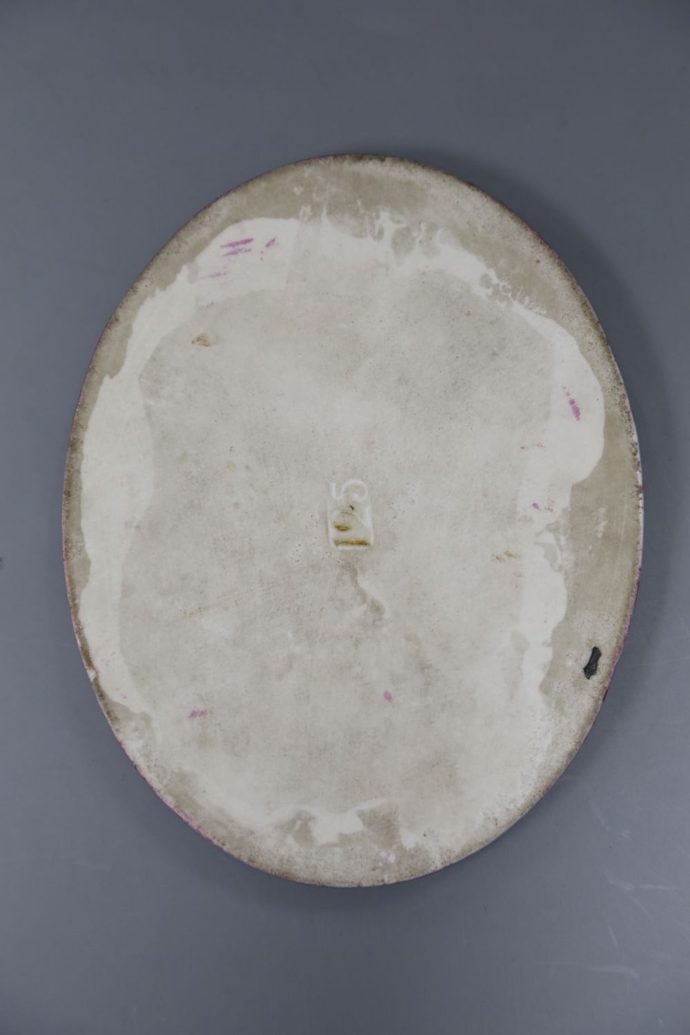 A Continental oval porcelain plaque depicting a girl, height 12.5cm